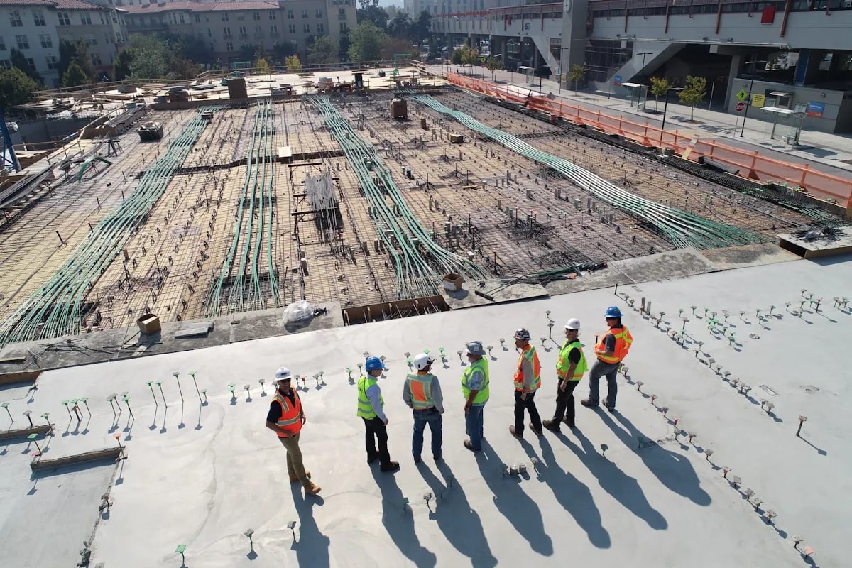 Construction team reviewing site plans outdoors